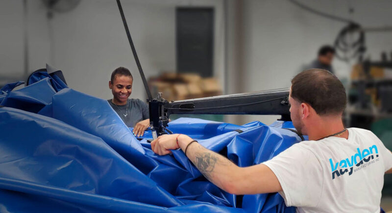 A picture of the Kayden Manufacturing team building a winter pool cover